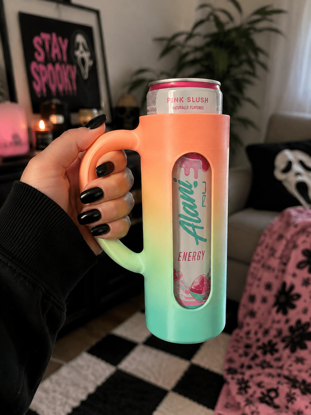 Purple 3D printed skinny can holder with handle holding an Alani Nu Pink Slush energy drink