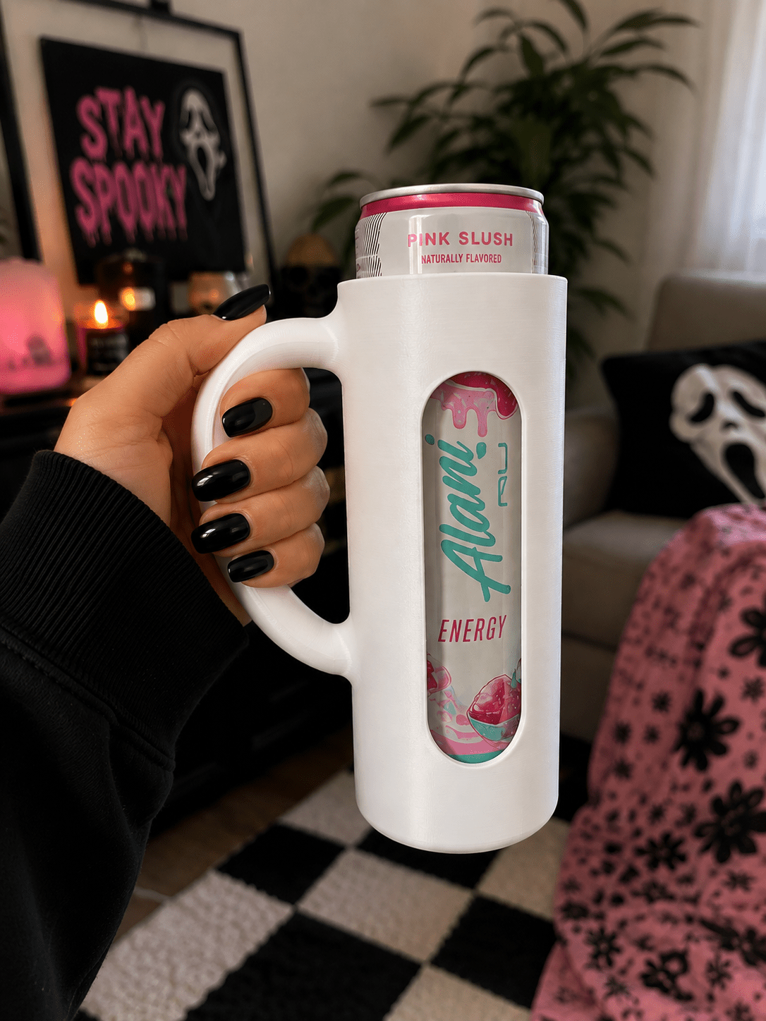 Green 3D printed skinny can holder with handle holding an Alani Nu Pink Slush energy drink