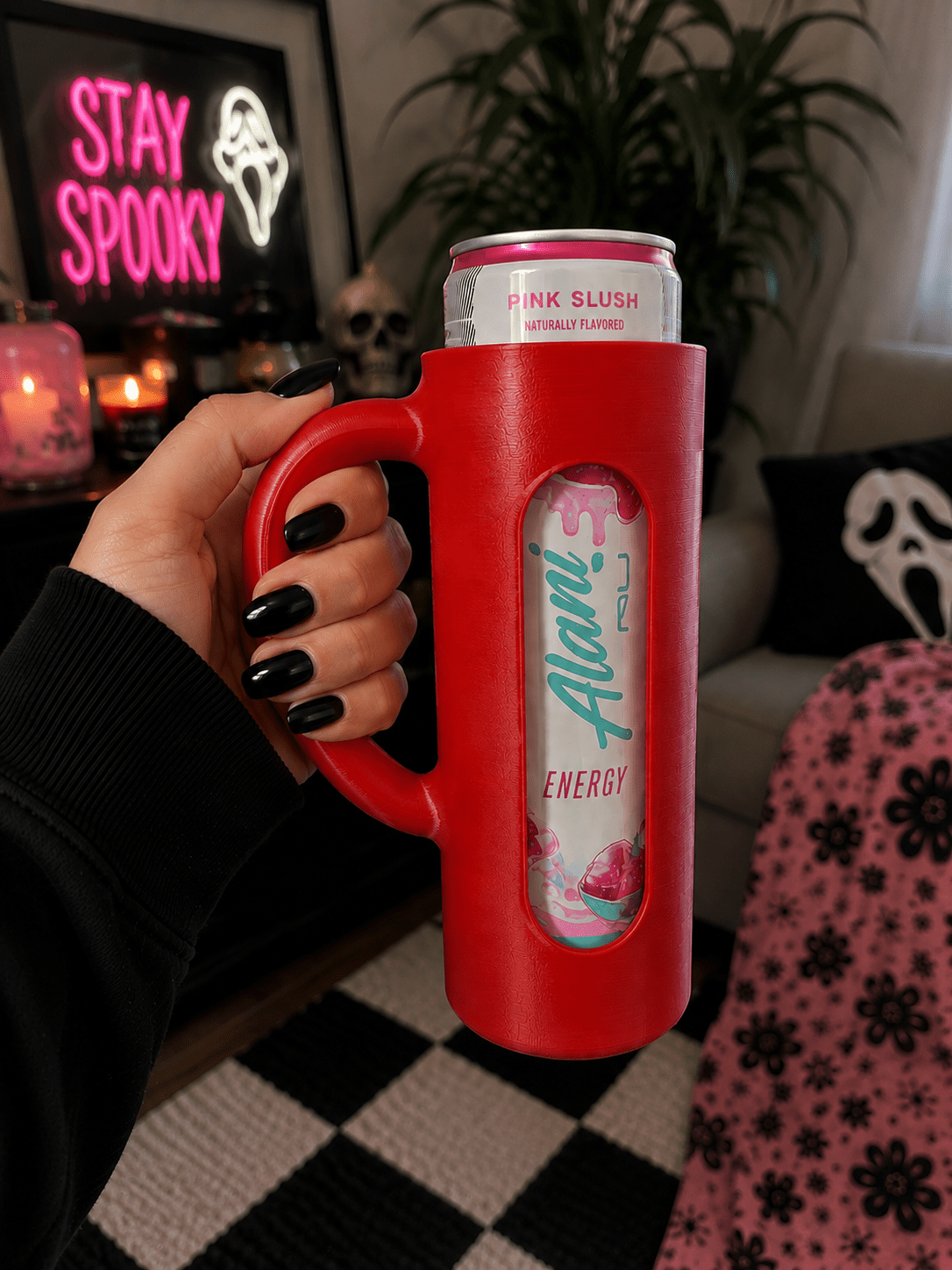Pink 3D printed skinny can holder with handle holding an Alani Nu Pink Slush energy drink