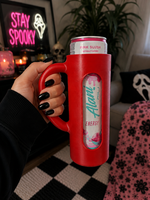 Pink 3D printed skinny can holder with handle holding an Alani Nu Pink Slush energy drink