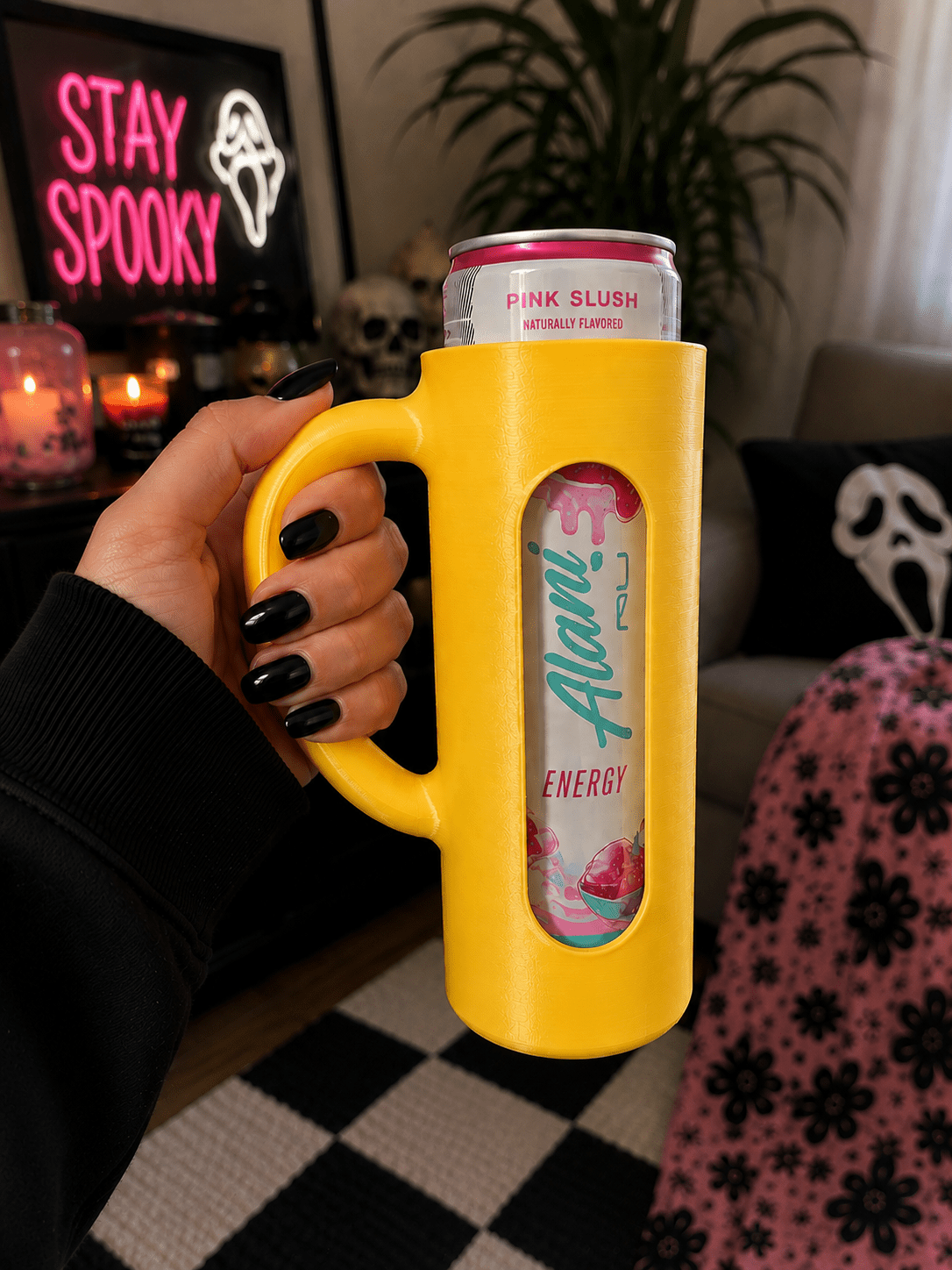 Red 3D printed skinny can holder with handle holding an Alani Nu Pink Slush energy drink